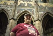 Me standing under beautiful relief artwork made into the walls of Castle of Prague in Czech Republic